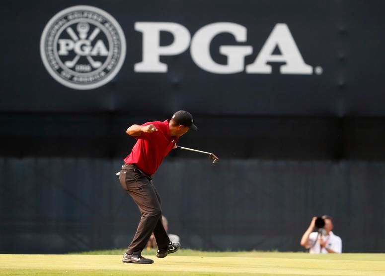 Tiger Woods celebrates his birdie putt on the 18th green Tiger Woods celebrates his birdie putt on the 18th green
